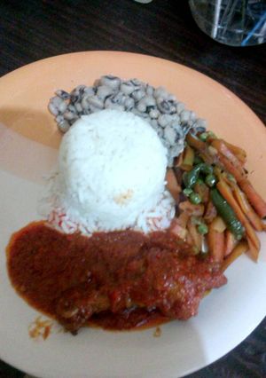 A picture of White Rice and beans with vegetables.