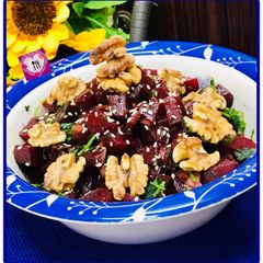 A picture of Mediterranean beet salad with dash of roasted walnuts.