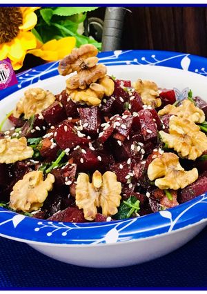A picture of Mediterranean beet salad with dash of roasted walnuts.