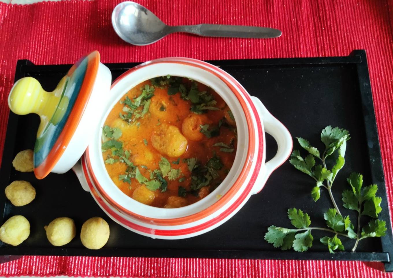 Dhania flavoured moong dal balls in red tomato curry