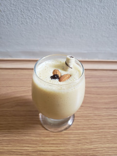 A picture of Tasty fruits and nuts milkshake.