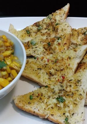 A picture of Garlic Bread Toast with corn chaat.