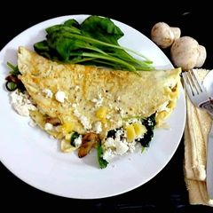 A picture of Greek Omelette with spinach and cheese.