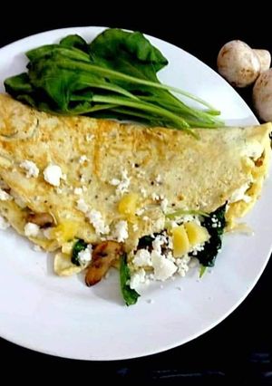 A picture of Greek Omelette with spinach and cheese.