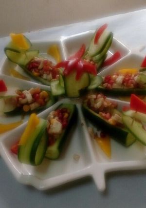 A picture of Cucumber, chickpea, pomegranate boat.