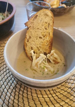 A picture of Creamy Mushroom soup, drizzle truffle oil, rustic croutons.