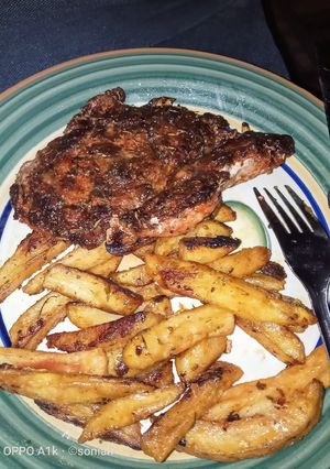 A picture of Fillet steak,served with cheesy potato chips.