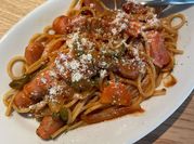 A picture of spaghetti with green pepper and carrots