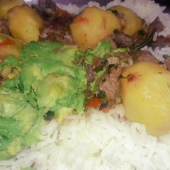 A picture of Mbuzi wet fry with rice.