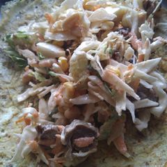 A picture of Fried egg with salad and chicken filling.