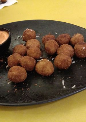 A picture of Cheesy bolls with tomato sauce.