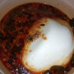 A picture of Tuwon masara with moringa soup.