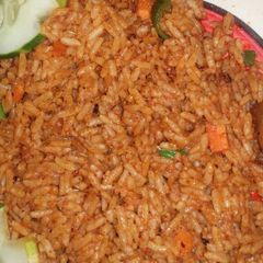 A picture of Garnish Jollof rice and fried chicken.