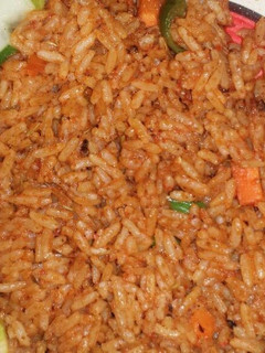 A picture of Garnish Jollof rice and fried chicken.