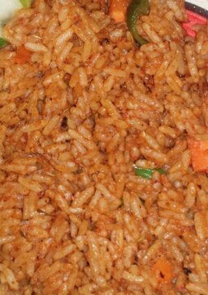 A picture of Garnish Jollof rice and fried chicken.