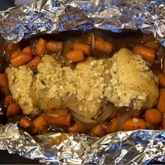A picture of Baked chicken wing with onion and carrot.