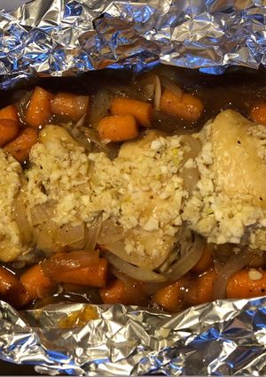 A picture of Baked chicken wing with onion and carrot.