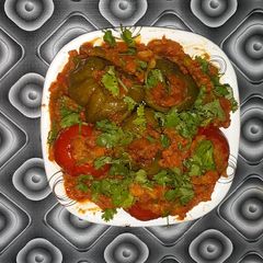 Baked stuffed capsicum and tomatoes curry A picture of Baked stuffed capsicum and tomatoes curry.