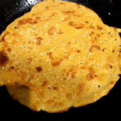 A picture of Besan ki roti with sesame seeds.