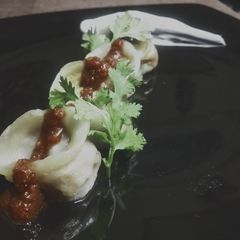 A picture of Soya Bean Ke Momos with Hot Garlic Sauce.