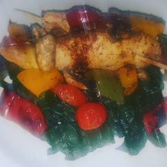 A picture of Grilled chicken breasts with vegetables.