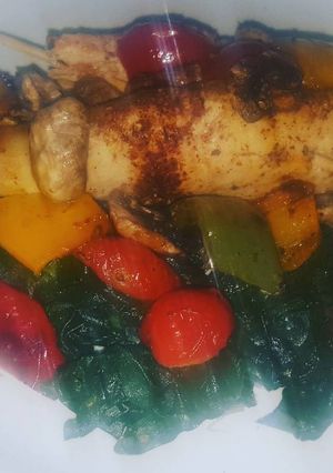 A picture of Grilled chicken breasts with vegetables.