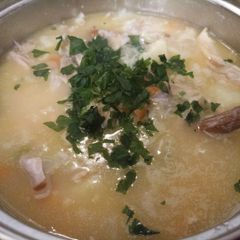 A picture of Chicken soup with vegetables.
