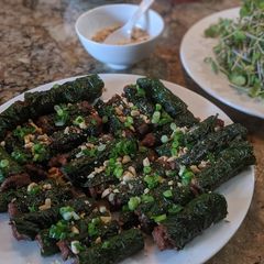 A picture of Bò lá lốt (Meat wrapped in betel leaf).