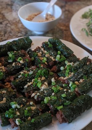 A picture of Bò lá lốt (Meat wrapped in betel leaf).