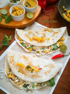 A picture of Spicy Mango salsa stuffed Dosa with Mango Sauce.