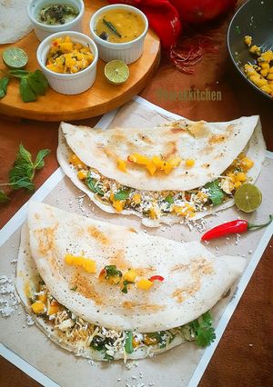 A picture of Spicy Mango salsa stuffed Dosa with Mango Sauce.