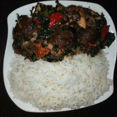 A picture of Boiled rice with vegetable sauce and snail.