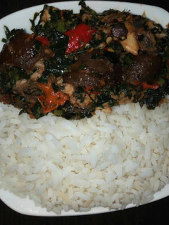 A picture of Boiled rice with vegetable sauce and snail.