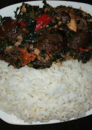 A picture of Boiled rice with vegetable sauce and snail.