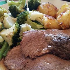A picture of Roast beef with steamed veg and roast potatoes.