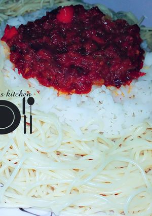 A picture of White rice and spaghetti with stew.