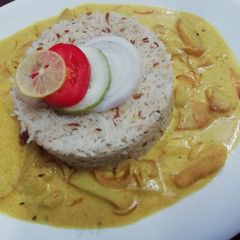 A picture of Jeera Rice with kadhi.