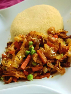 A picture of Shredded chicken sauce with couscous.