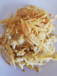 Una foto de Revuelto de bacalao con puerros y corona de patatas paja
