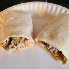 A picture of Steak or chicken with corn and black bean wraps.