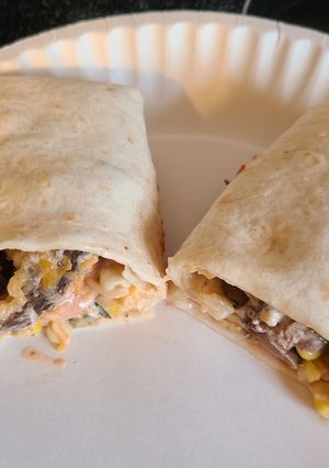 A picture of Steak or chicken with corn and black bean wraps.