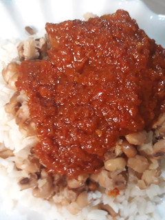 A picture of Rice and beans with stew.