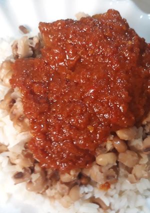 A picture of Rice and beans with stew.