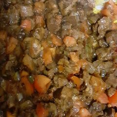 A picture of Chicken gizzards with tomatoes.