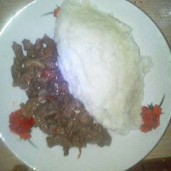 A picture of Ugali served with filed beef.