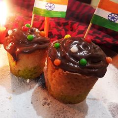 A picture of Tricolor cupcakes with chocolate Ganache.