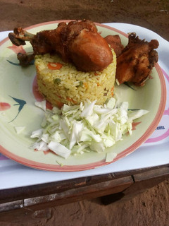 A picture of Fried rice and chicken.