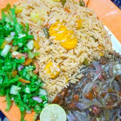 A picture of Oriental jollof rice, steamed fish with lemon salad.