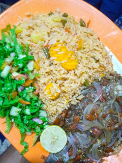 A picture of Oriental jollof rice, steamed fish with lemon salad.