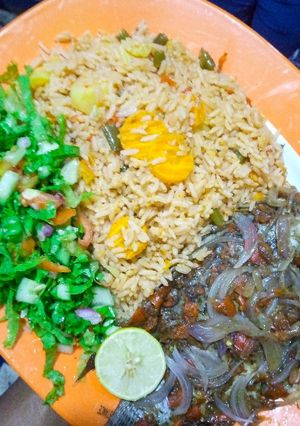 A picture of Oriental jollof rice, steamed fish with lemon salad.